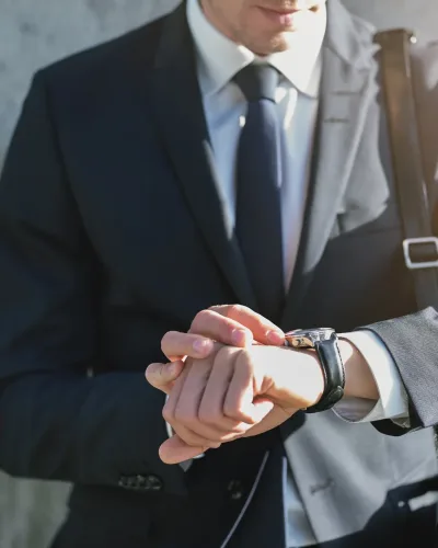 Stylish man wearing suit looks at watch